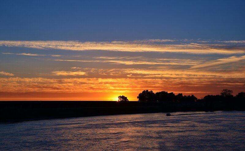 Sunset over a river at dusk