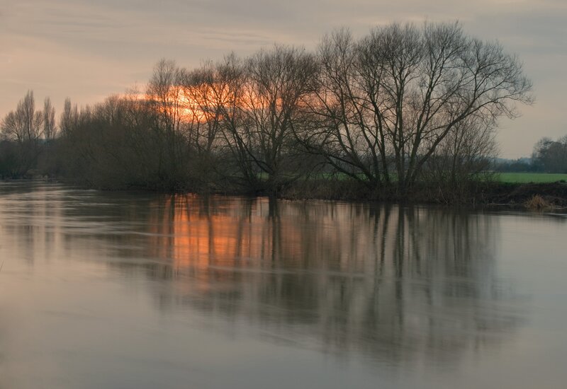Sunset over a river at dusk