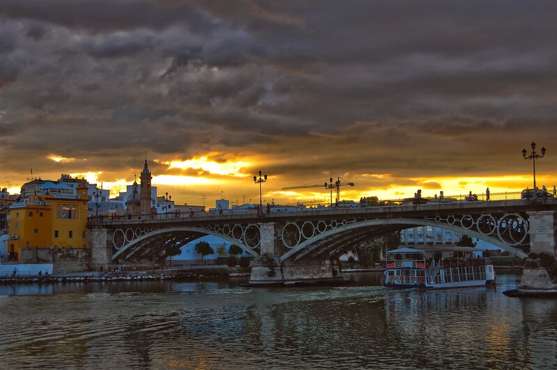 Sunset over a river bridge