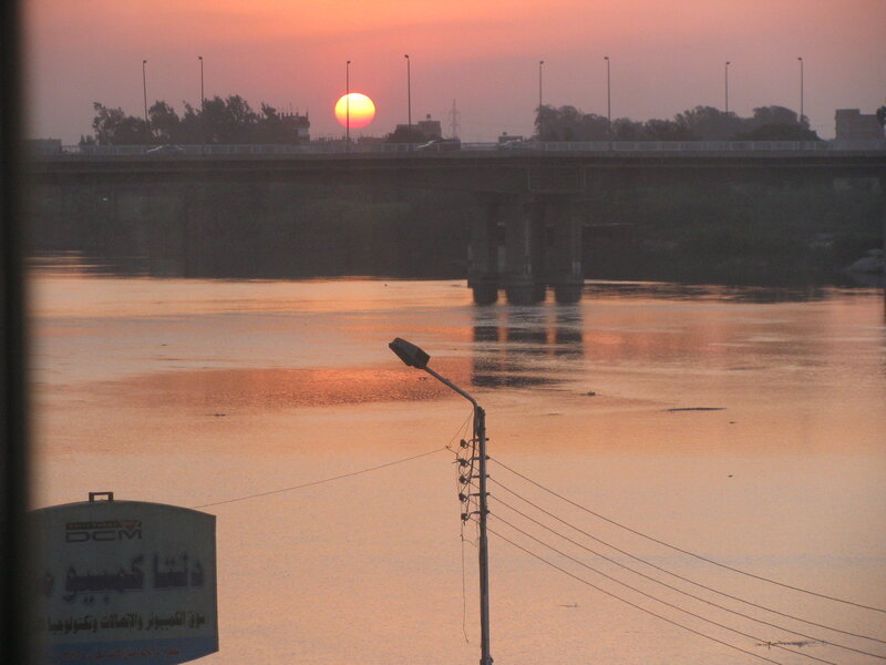sunset over a river bridge