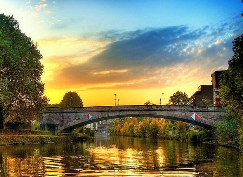 Sunset over a river bridge