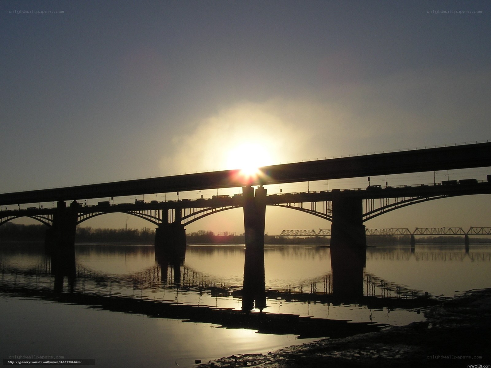 Sunset over a river bridge