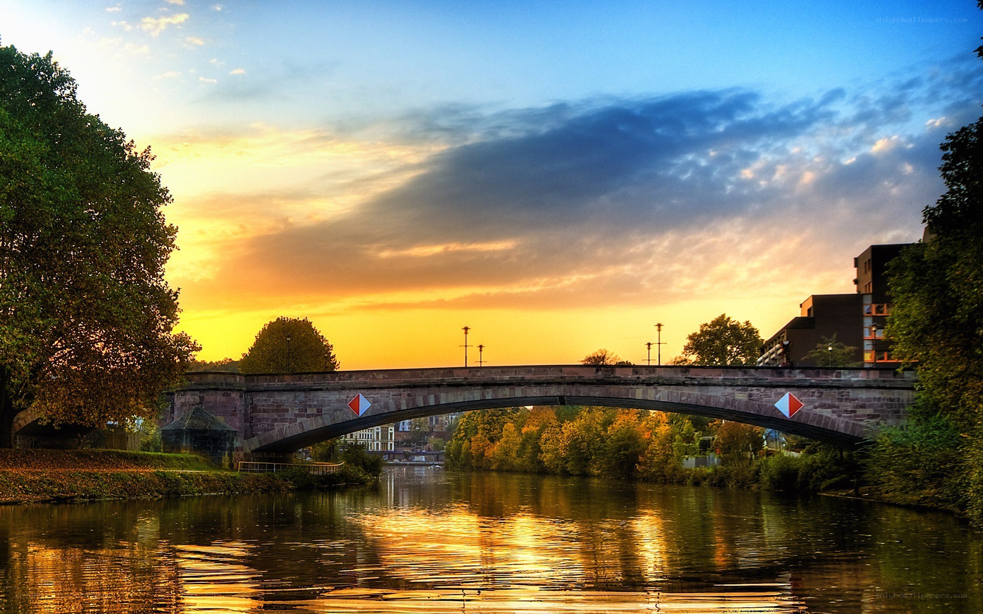 Sunset over a river bridge