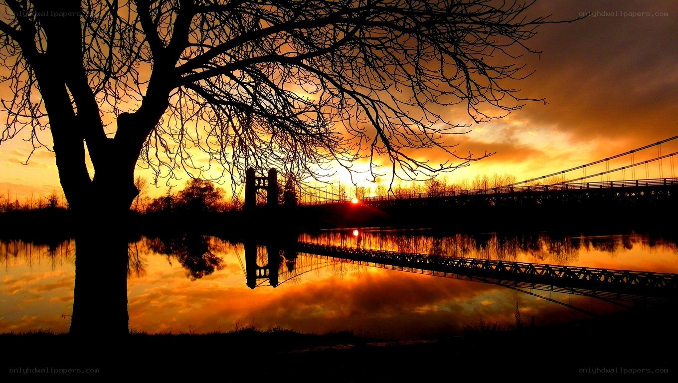 Sunset over a river bridge