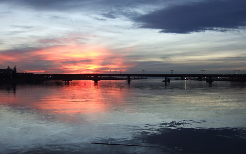 sunset over a river bridge