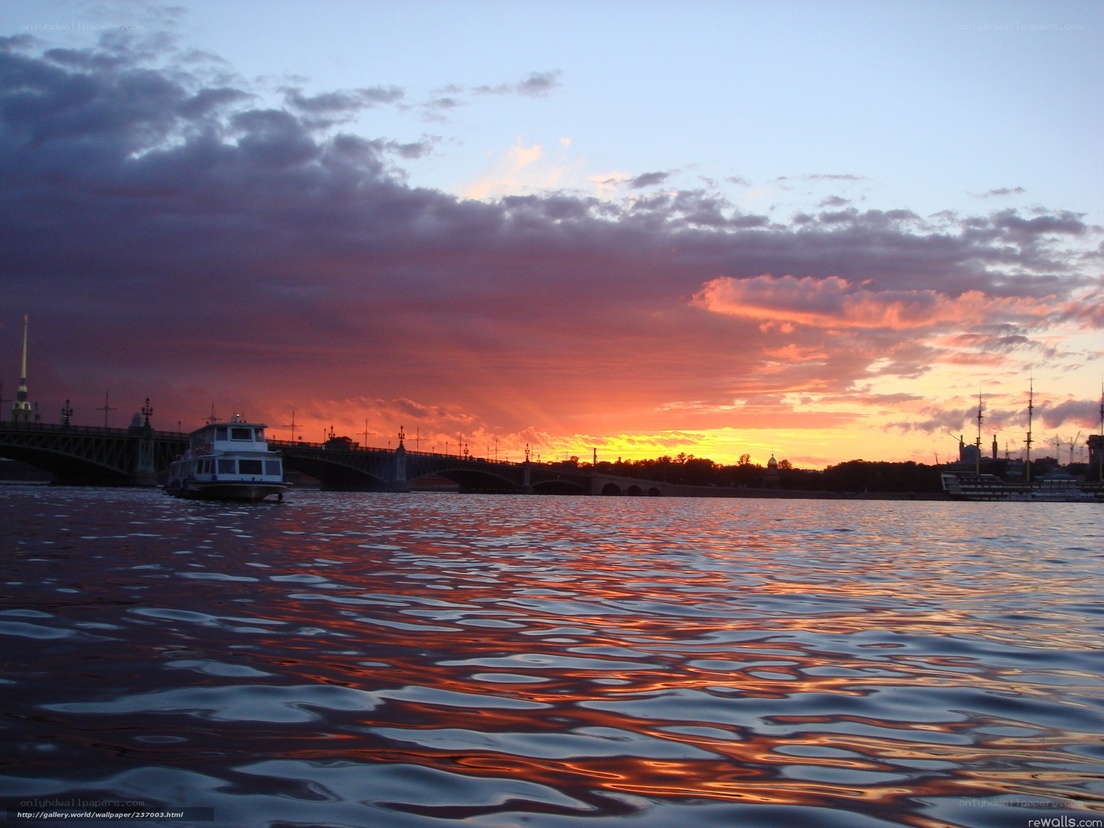 Sunset over a river with a boat