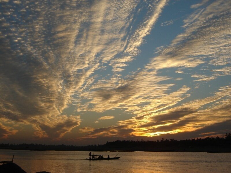 Sunset over a river with boat