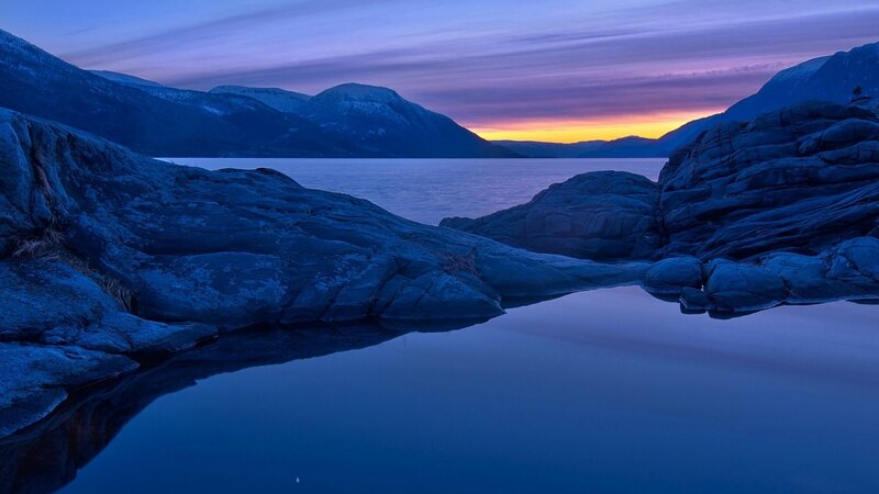 Sunset over a rocky fjord