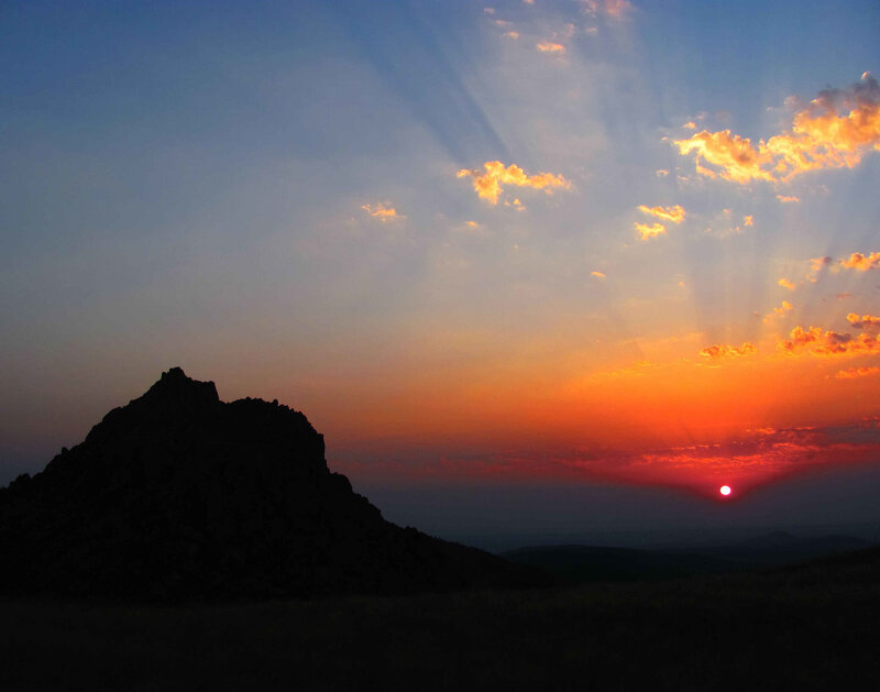 Sunset over a rocky hill