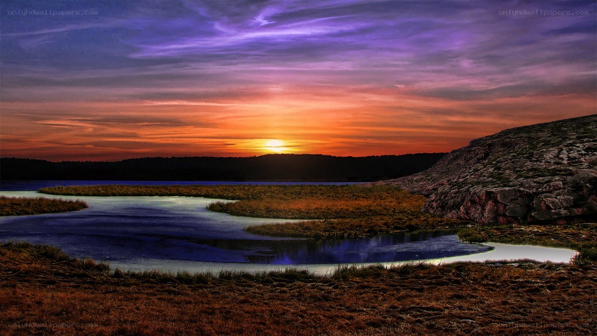 Sunset over a rocky lake