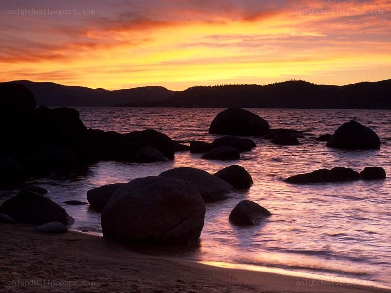 Sunset over a rocky lakeshore