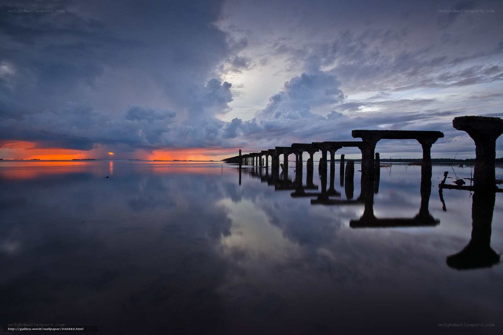 Sunset over a ruined pier