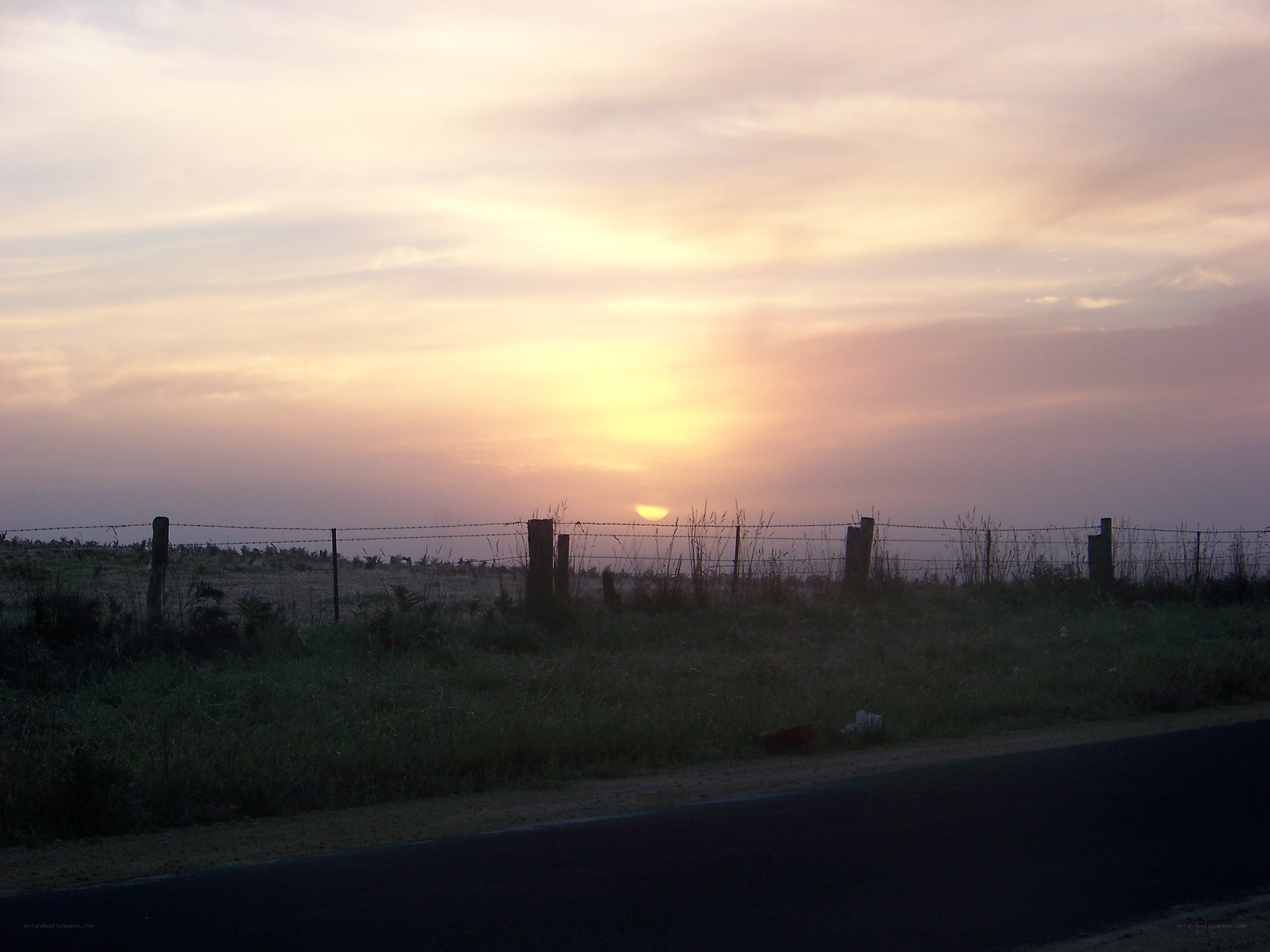 sunset over a rural fence