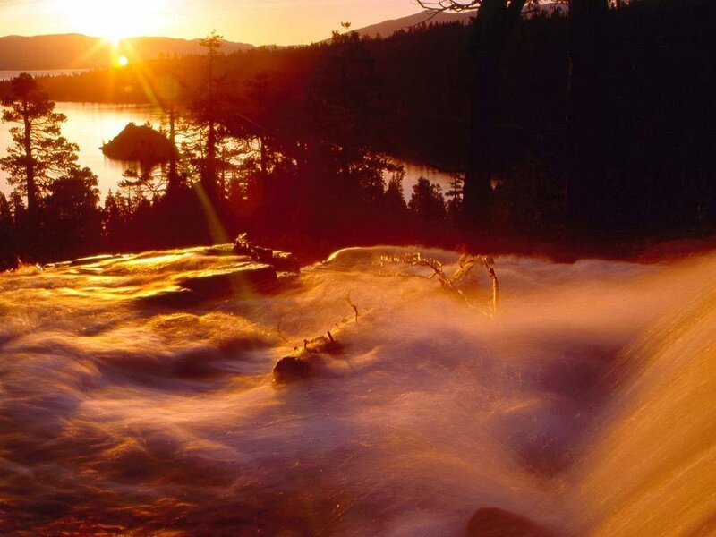 Sunset over a rushing waterfall