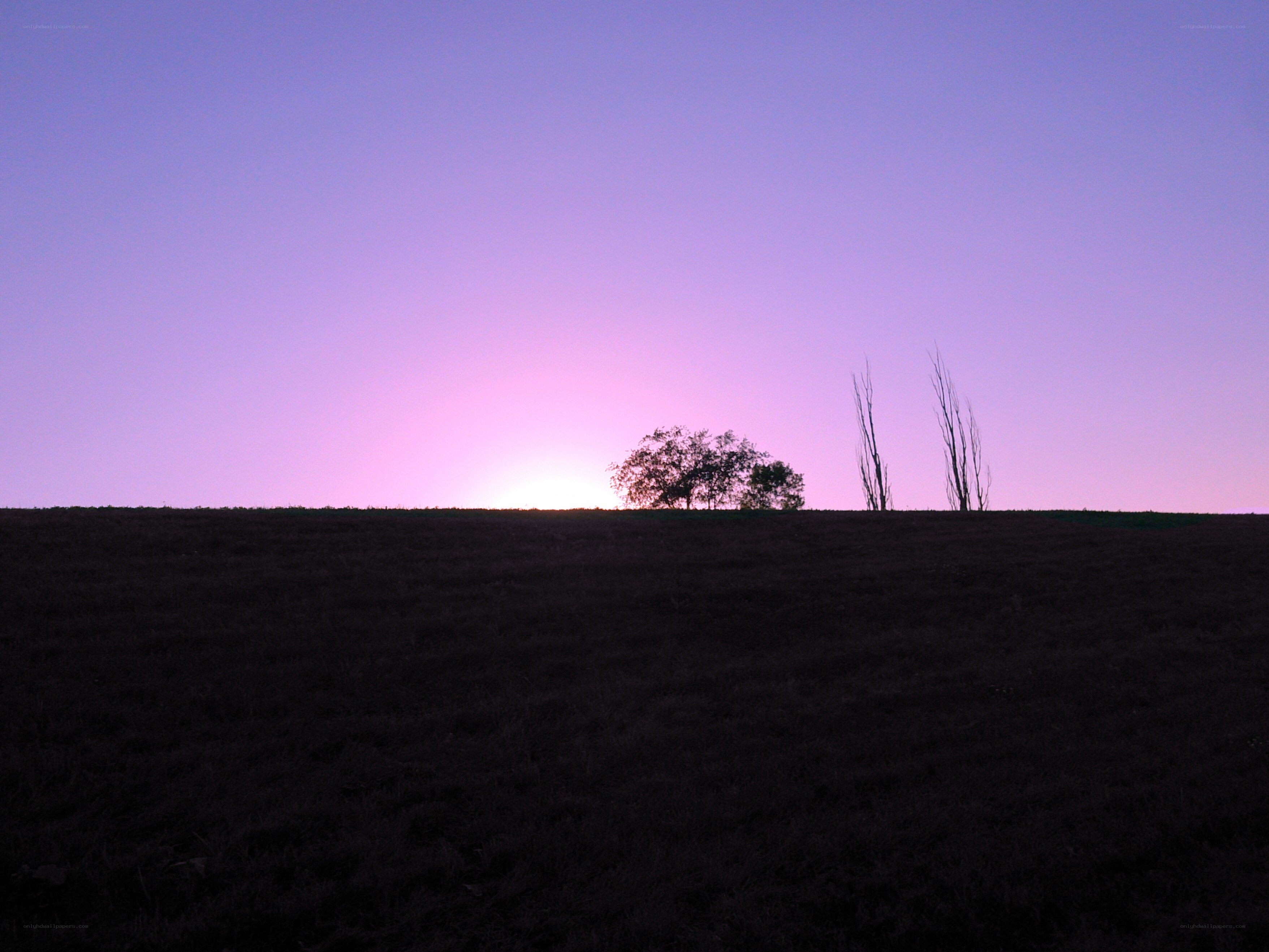 Sunset over a silhouetted hill