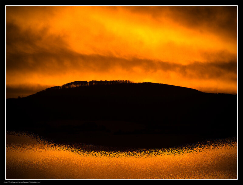 Sunset over a silhouetted hill