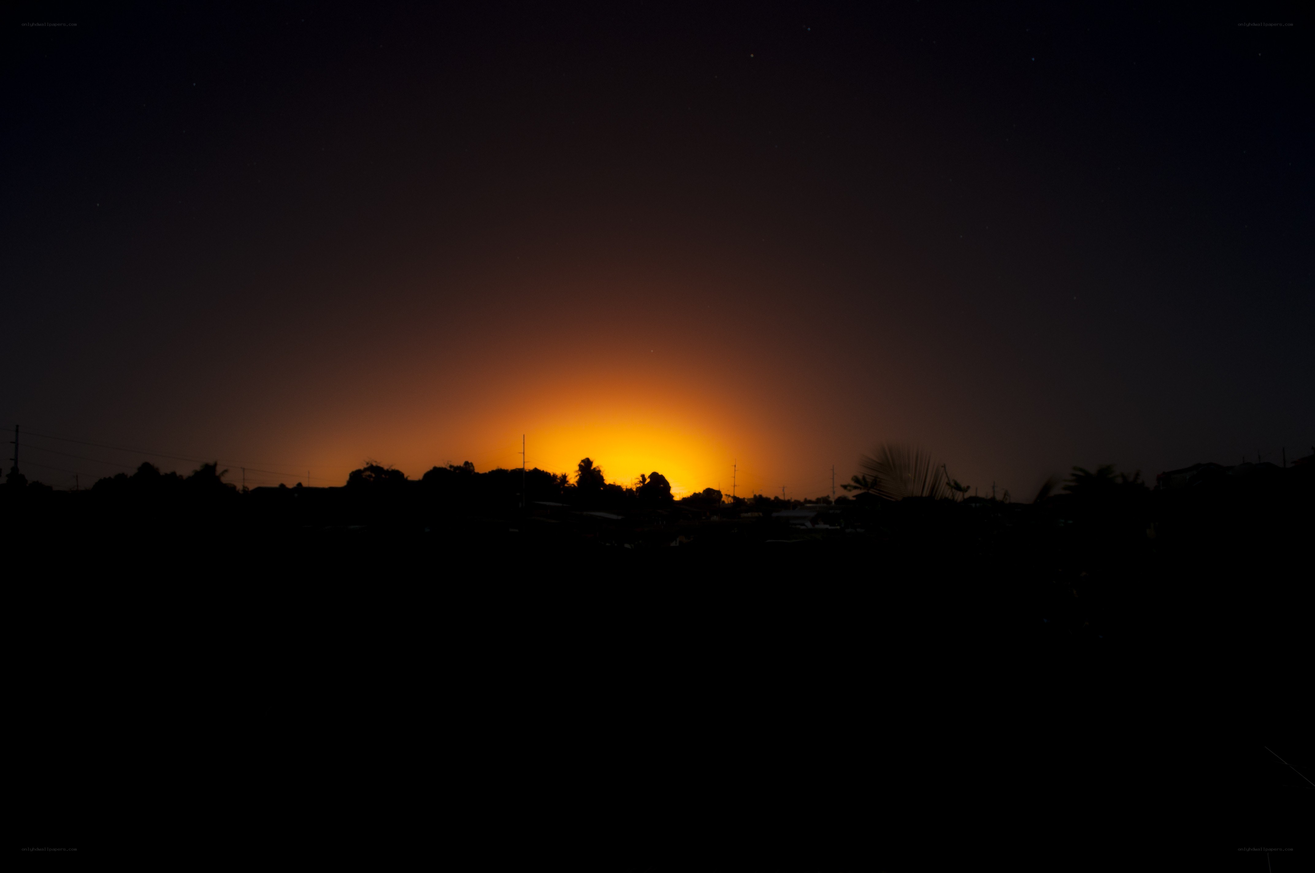 Sunset over a silhouetted landscape
