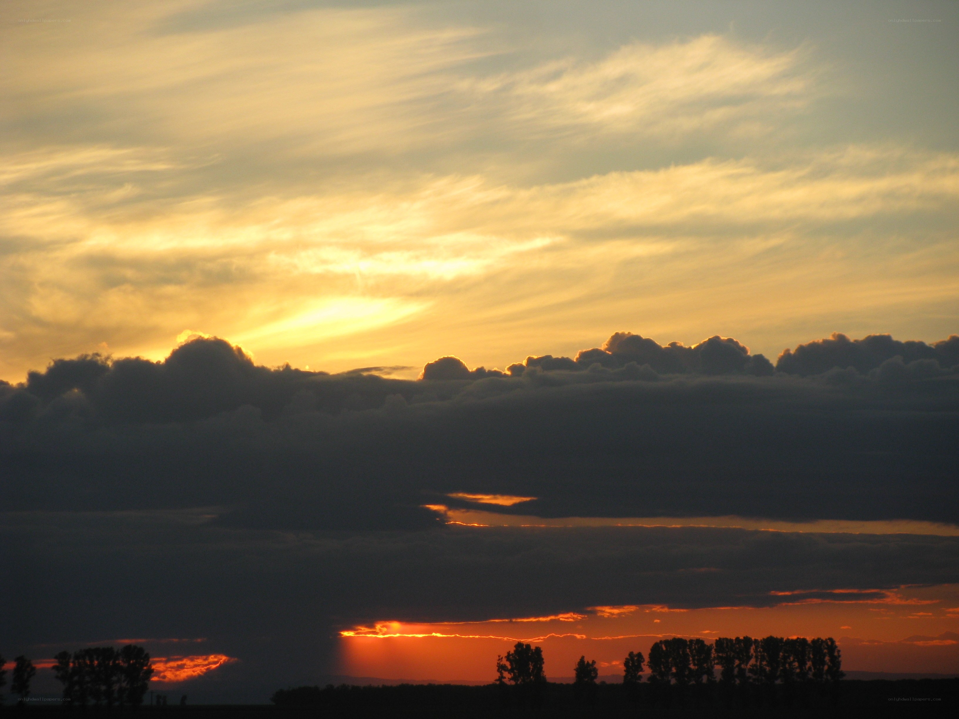Sunset over a silhouetted landscape