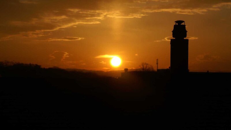 Sunset over a silhouetted tower