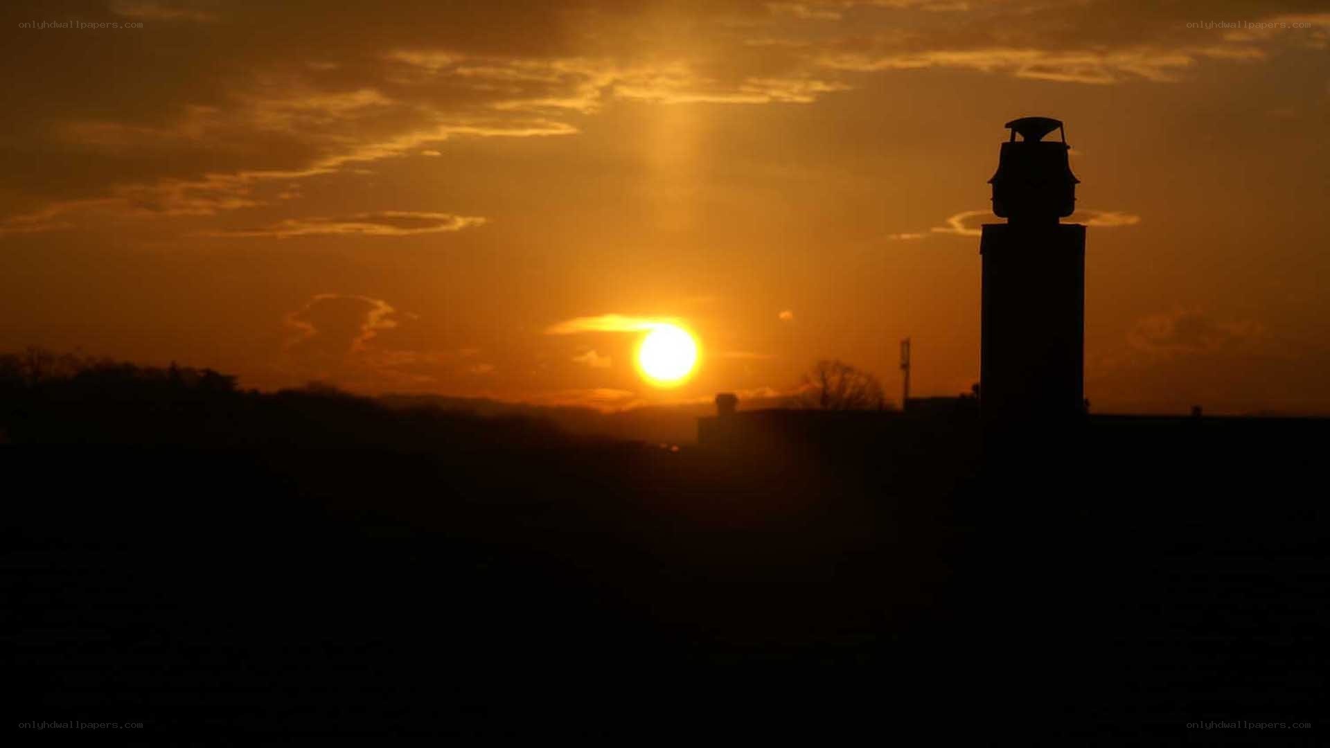 Sunset over a silhouetted tower