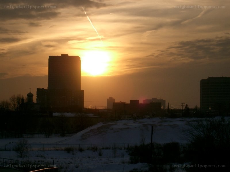 Sunset over a snowy city