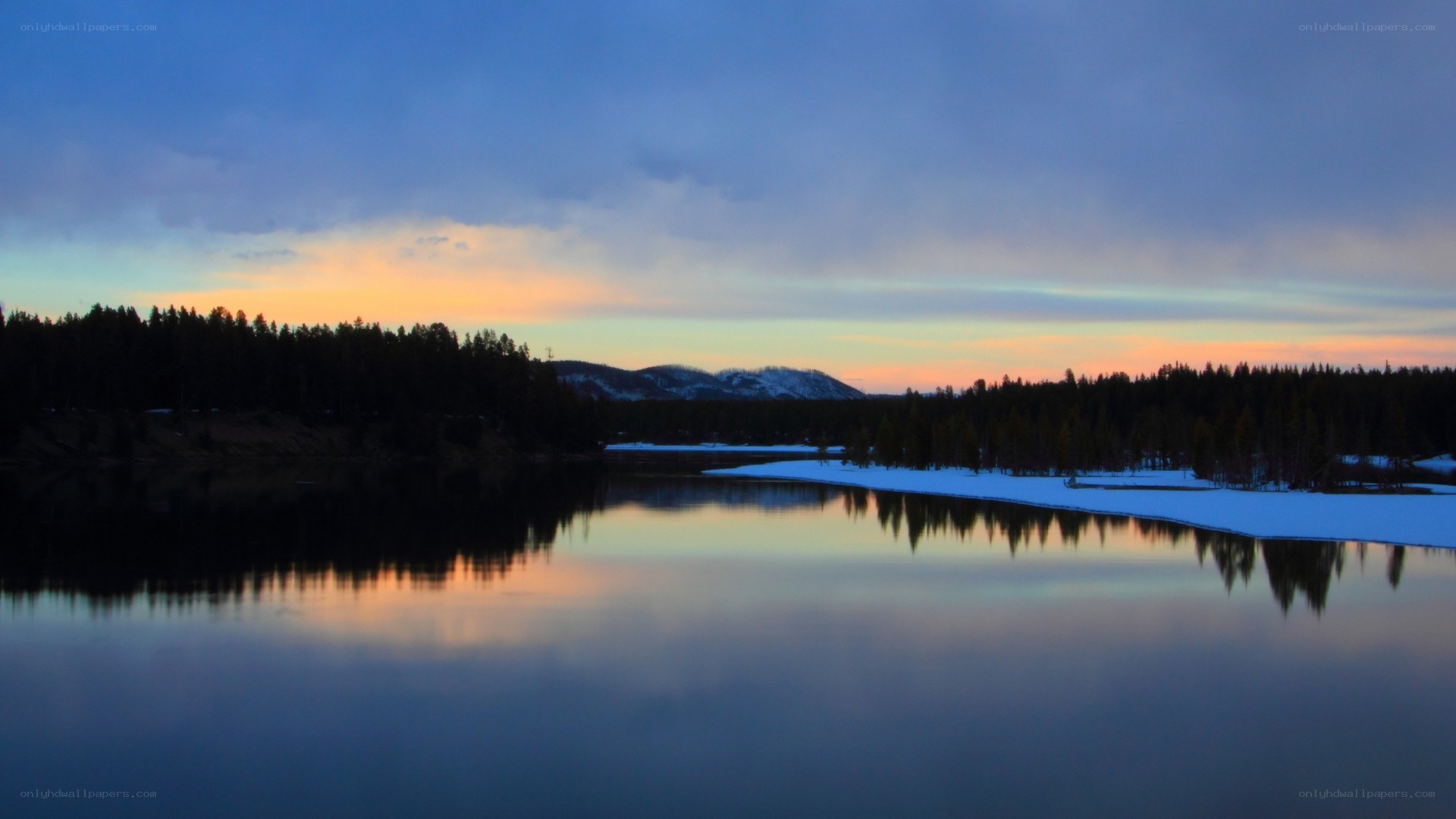 sunset over a snowy lake