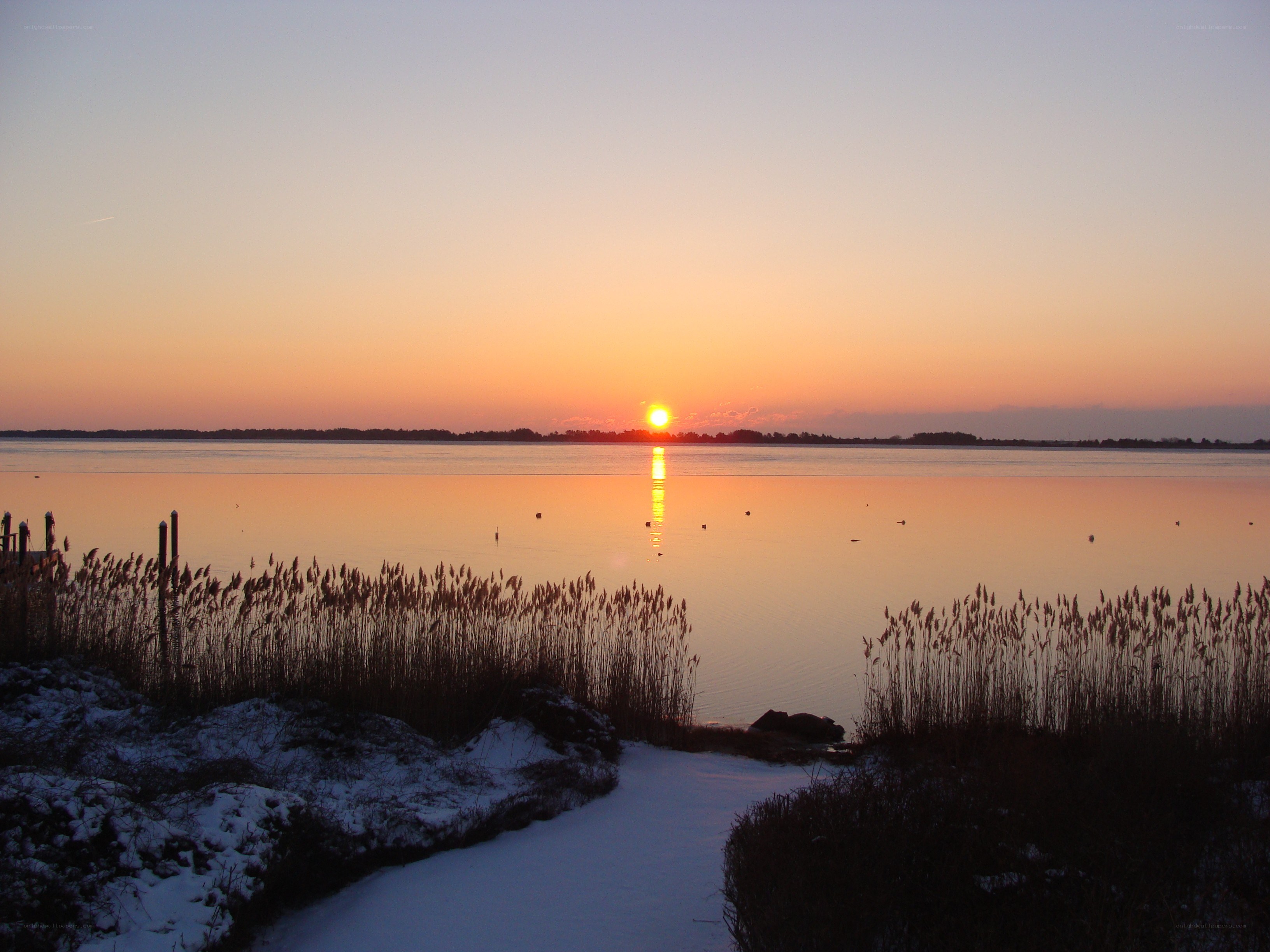 Sunset over a snowy lake