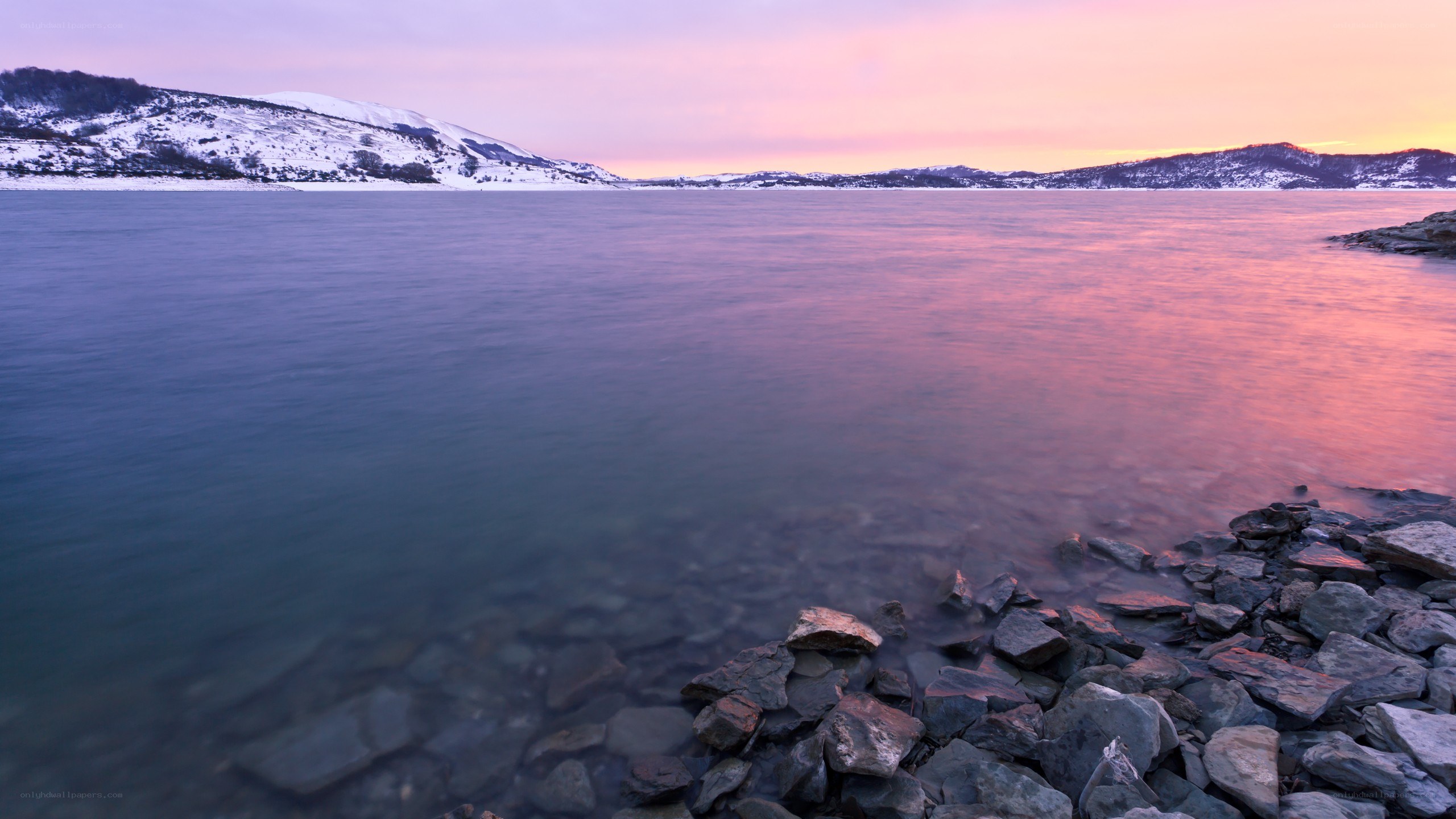 sunset over a snowy lake