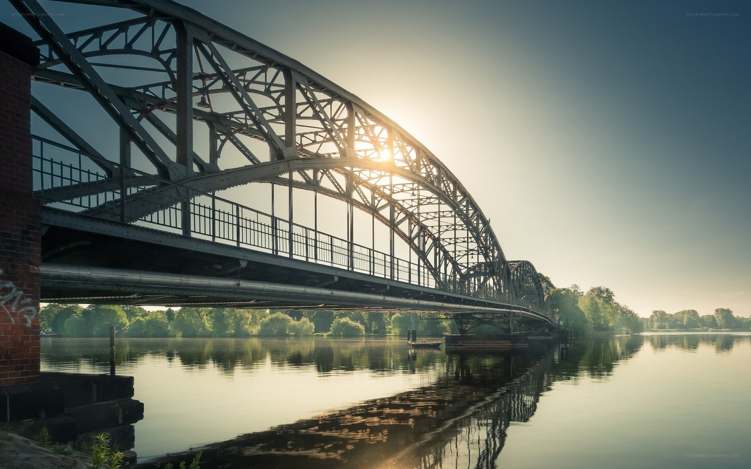 Sunset over a steel arch bridge