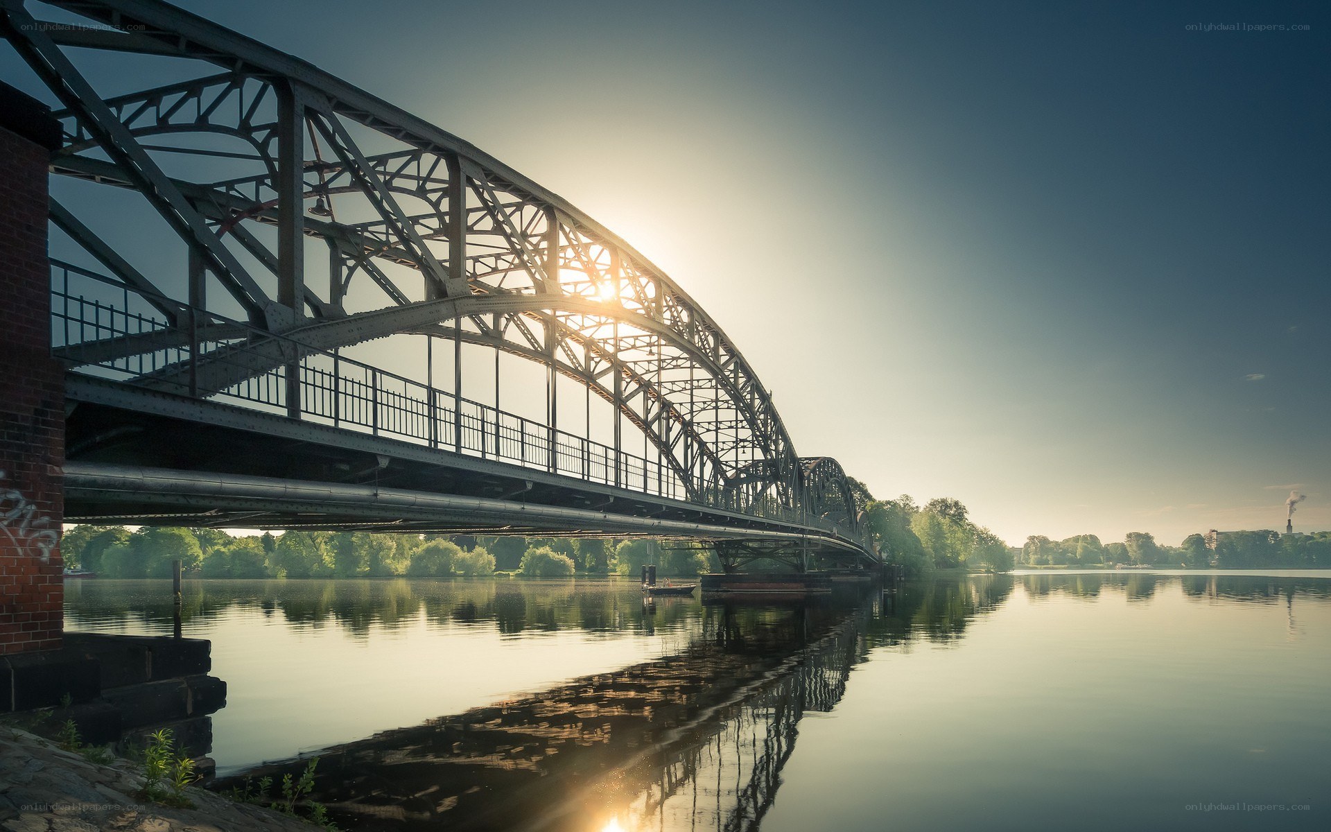 Sunset over a steel arch bridge