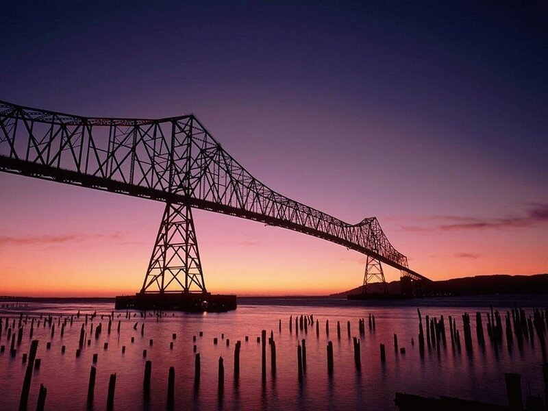 sunset over a steel bridge
