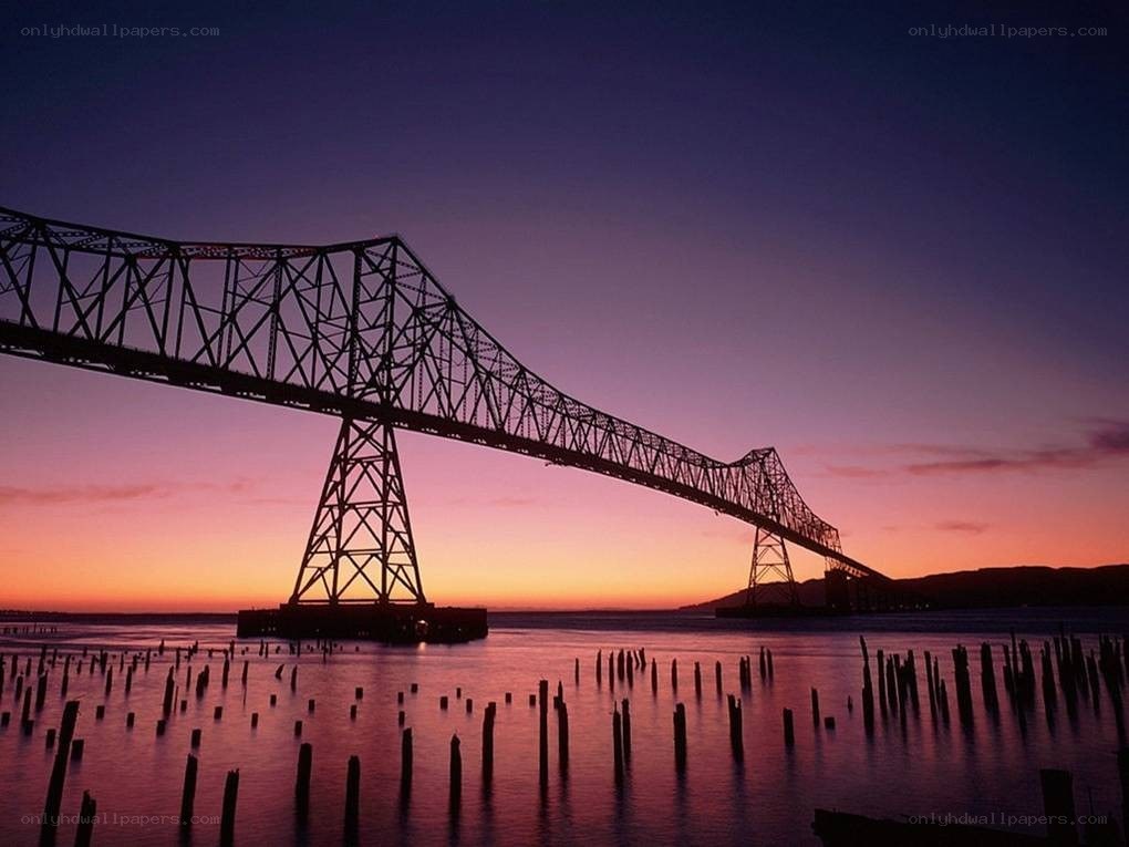 sunset over a steel bridge
