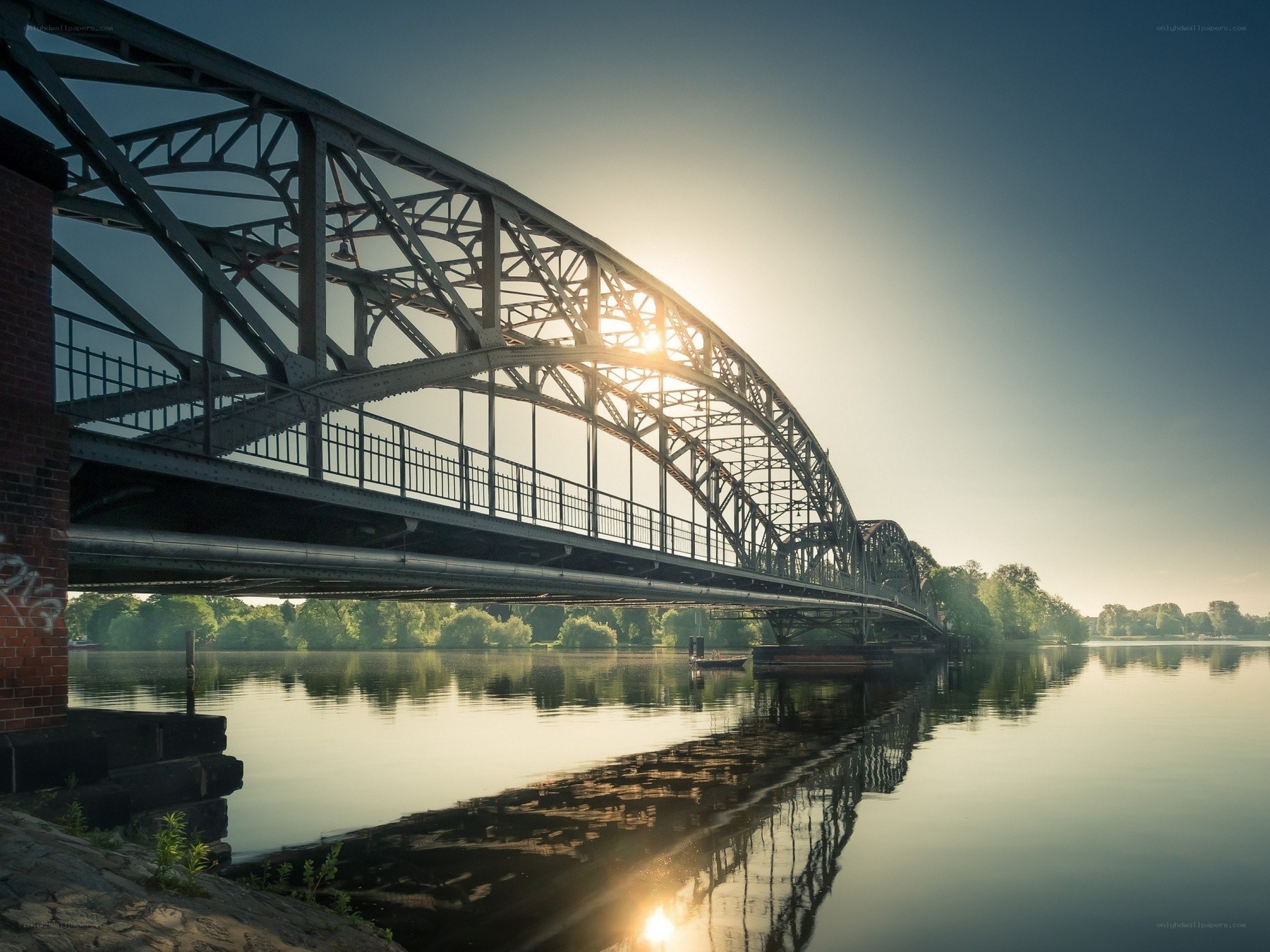 Sunset over a steel truss bridge