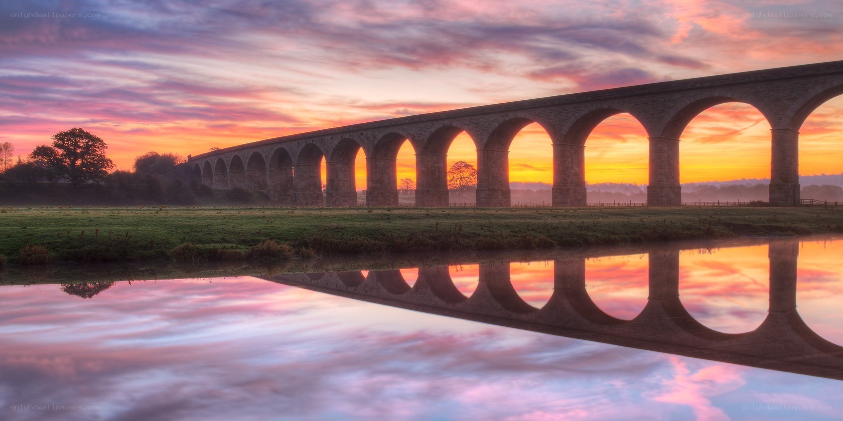 Sunset over a stone aqueduct
