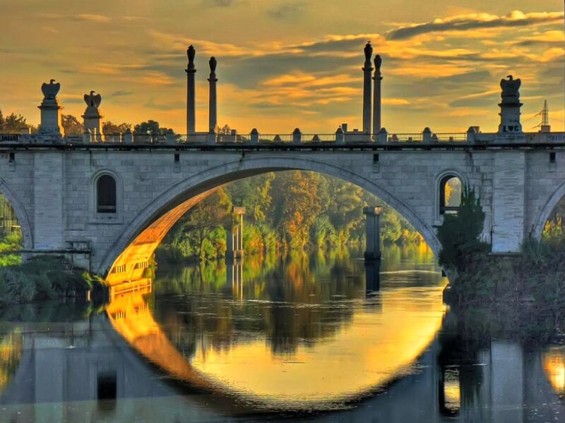 Sunset over a stone bridge