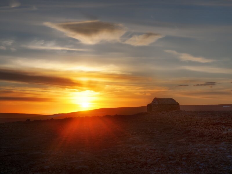 Sunset over a stone hut
