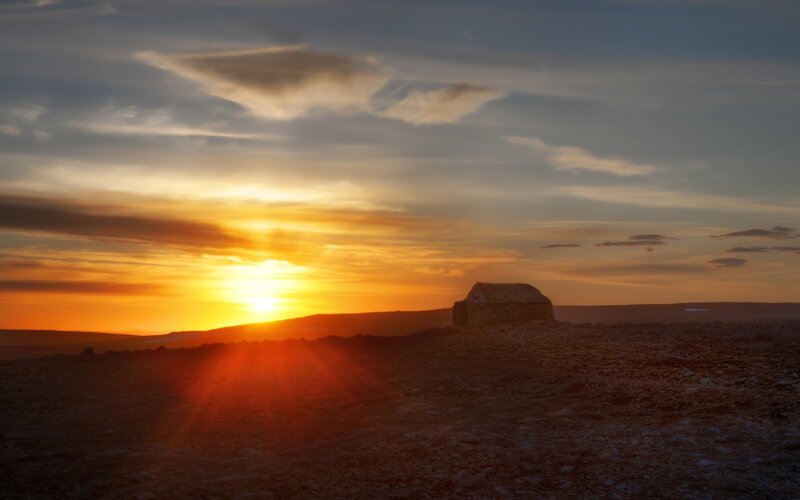 Sunset over a stone hut