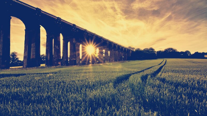 Sunset over a stone viaduct