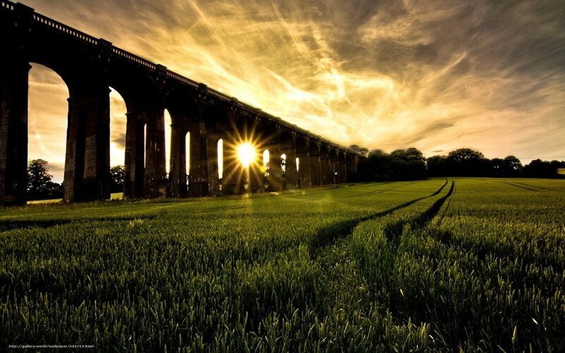 Sunset over a stone viaduct