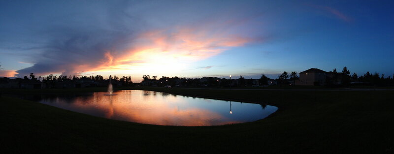 sunset over a suburban pond
