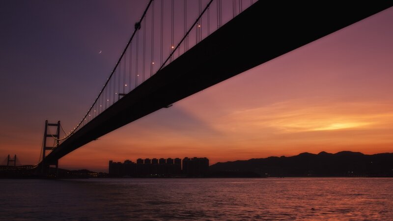 sunset over a suspension bridge