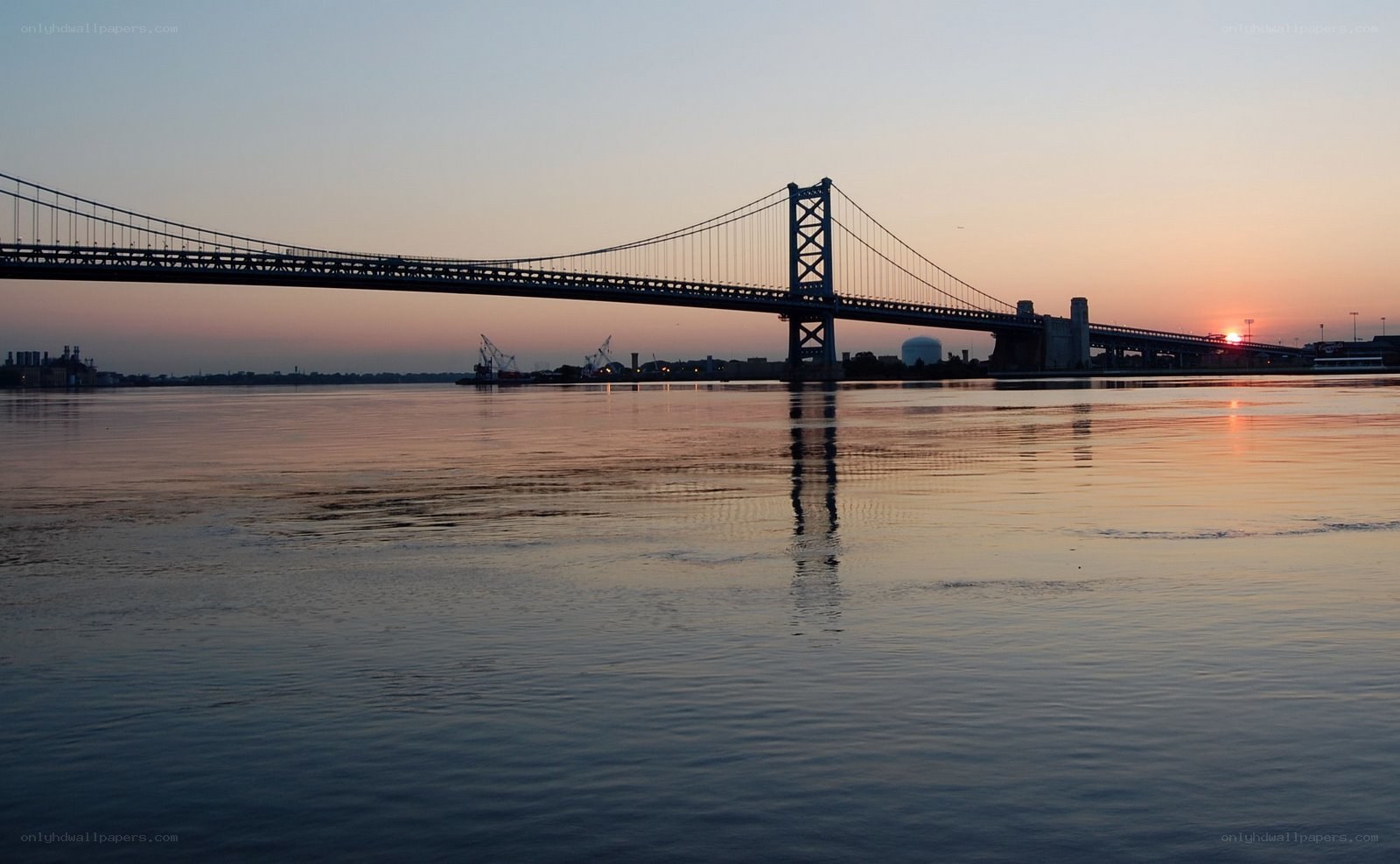 sunset over a suspension bridge
