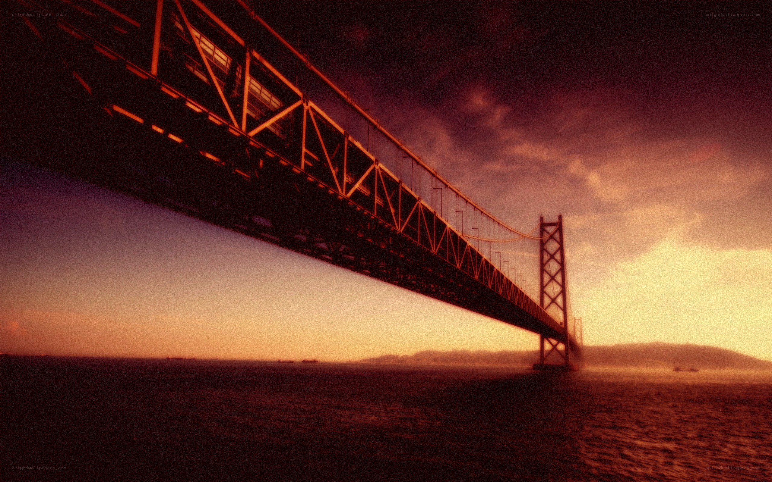 sunset over a suspension bridge