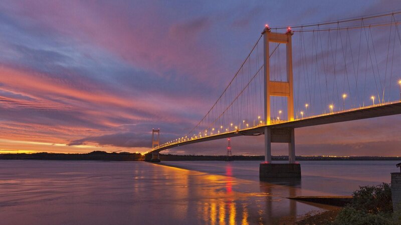 sunset over a suspension bridge
