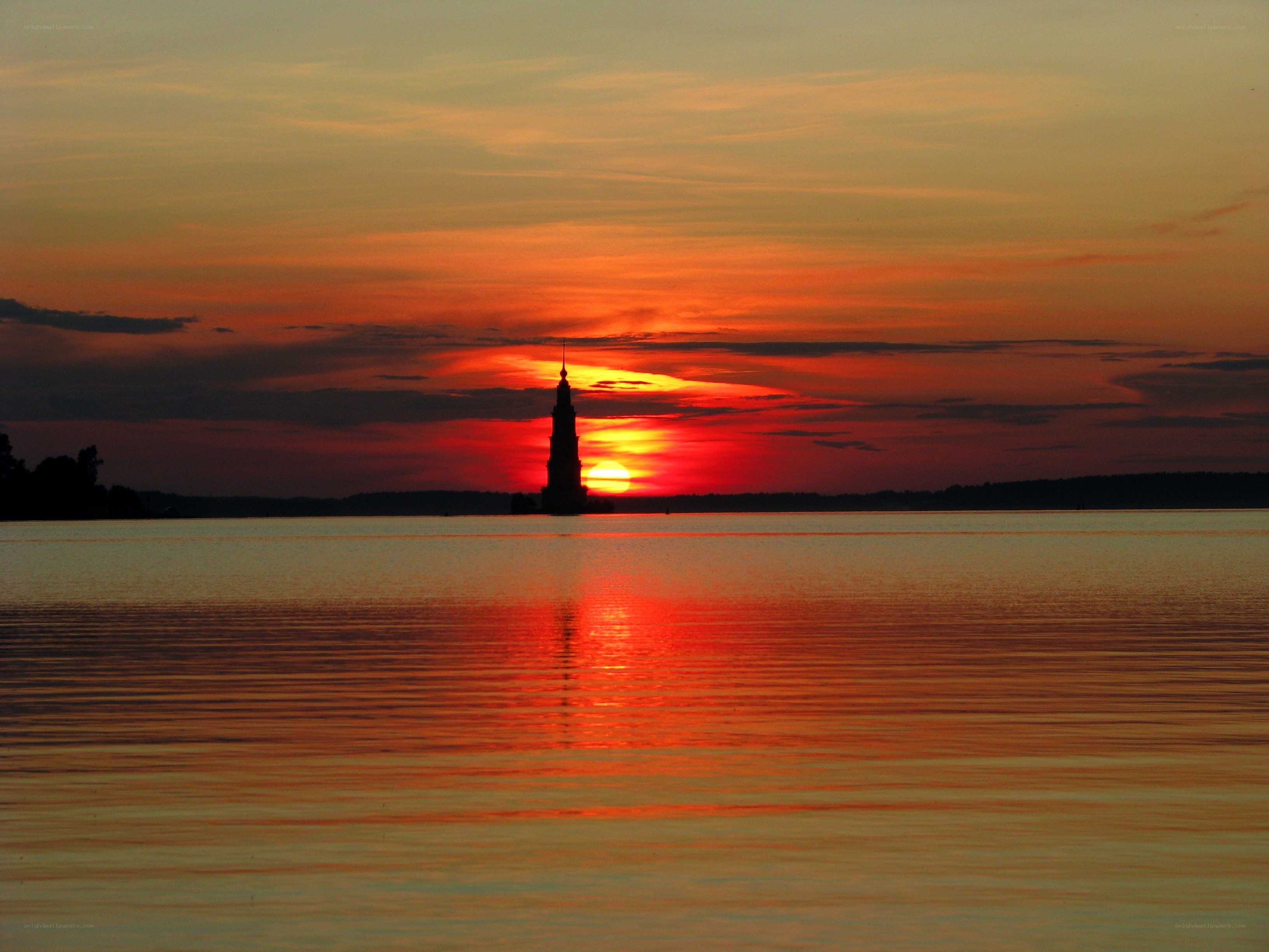 Sunset over a tower on water