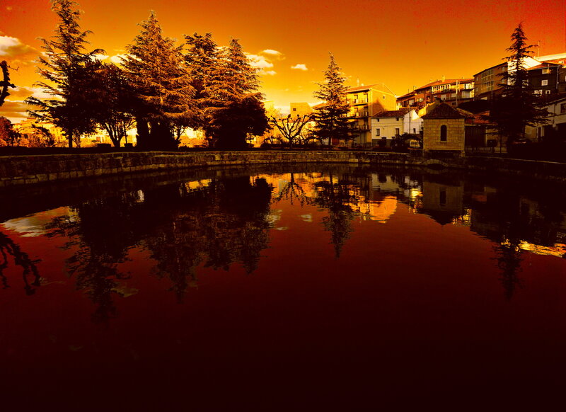 Sunset over a town pond