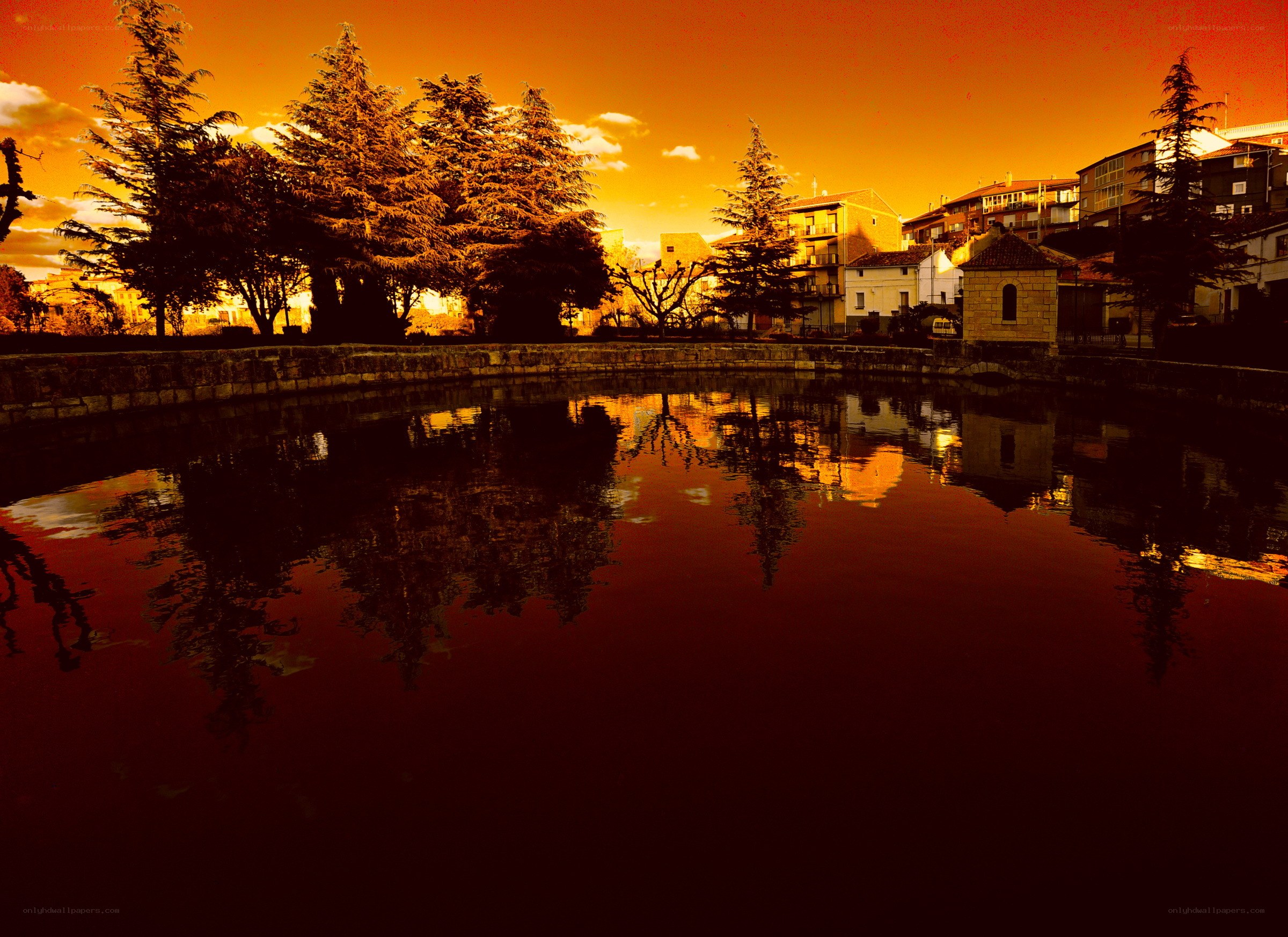 Sunset over a town pond