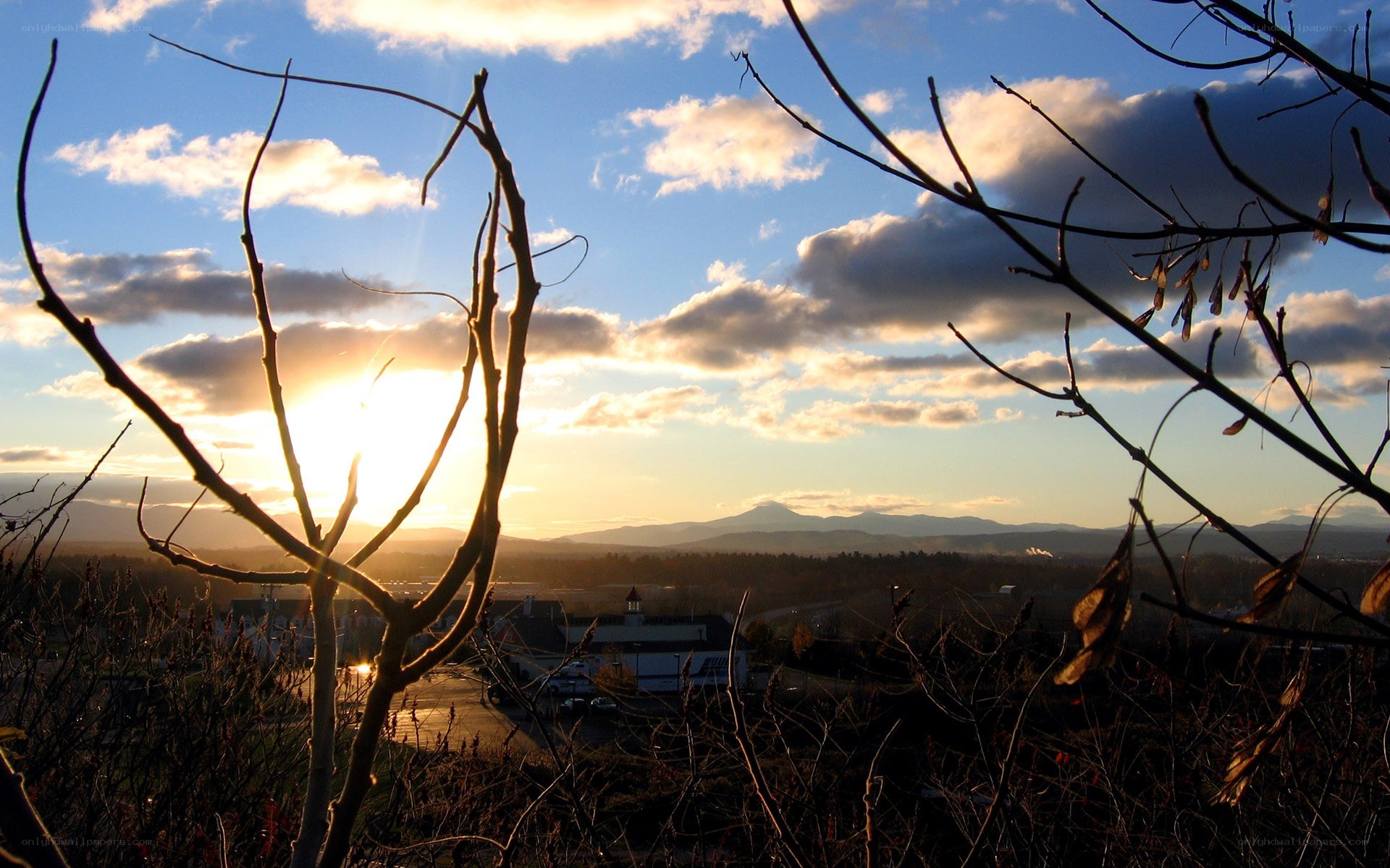 Sunset over a town with mountains