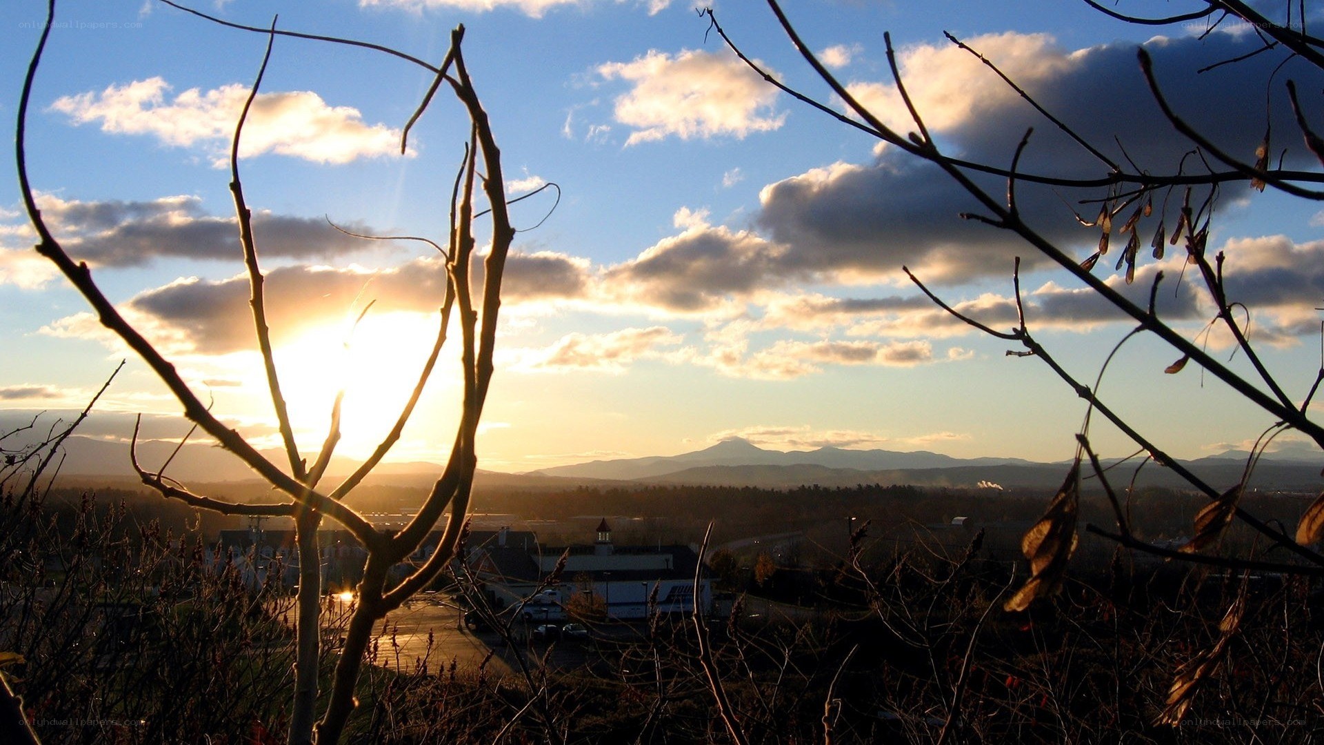 Sunset over a town with mountains