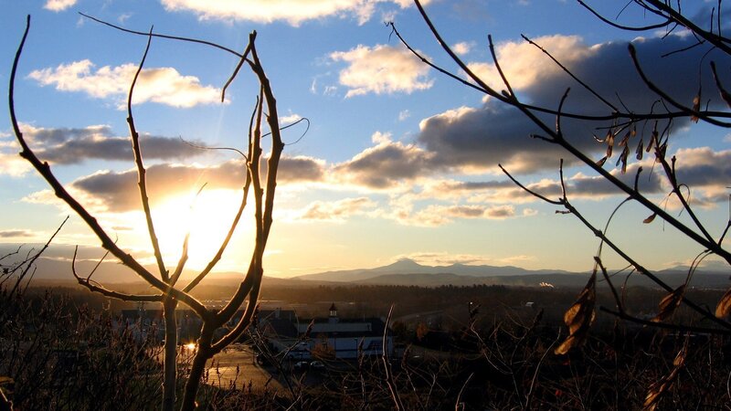 Sunset over a town with mountains